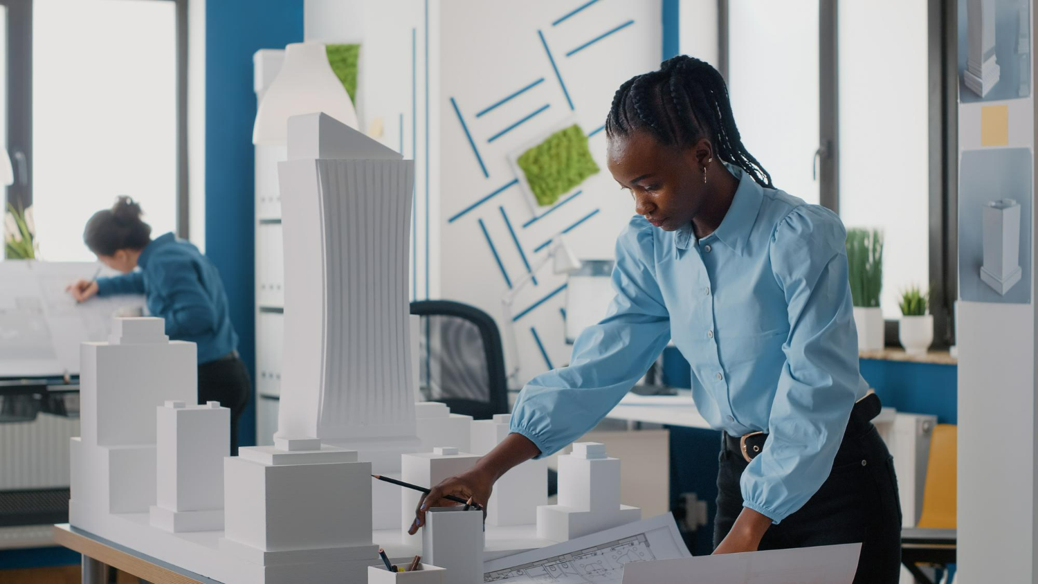 african-american-woman-analyzing-blueprints-plan-building-model-work-architecture-architect-working-with-maquette-layout-print-design-urban-construction-development